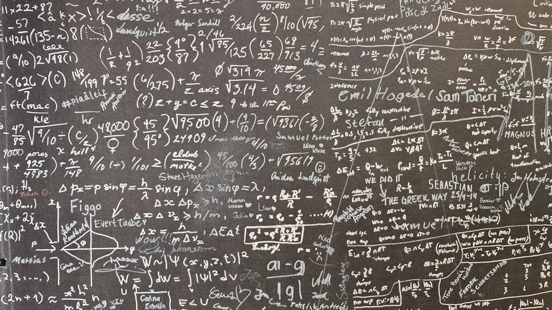 Quadro negro coberto de equações matemáticas e fórmulas escritas com giz